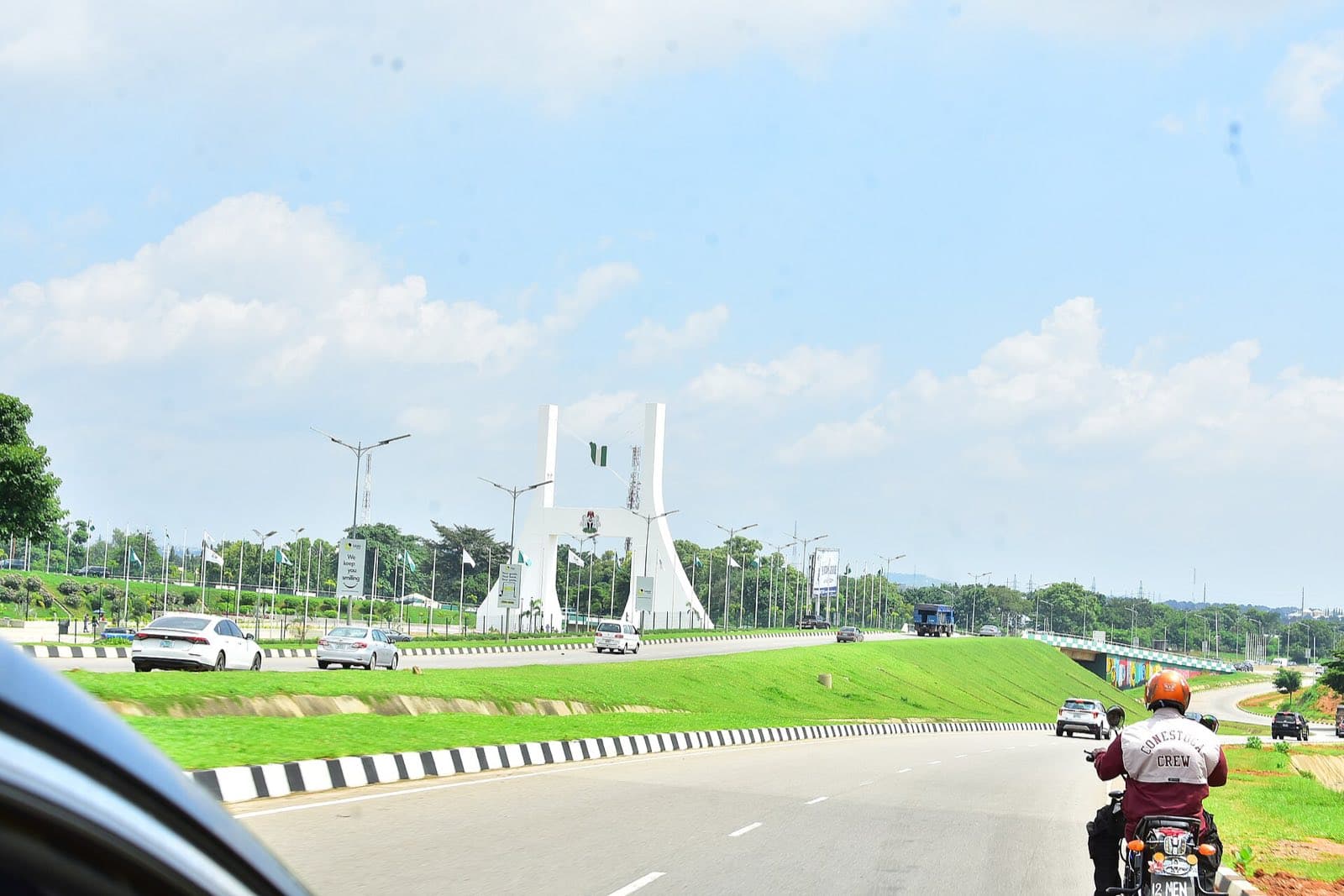 The Abuja City Gate beside an open city highway